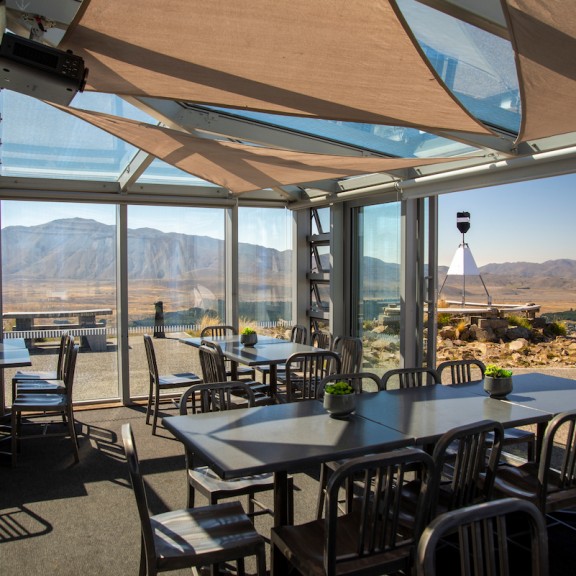 Astro cafe tables shown with mountain top views 