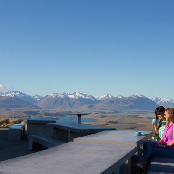 Couple dining outside at the Astro cafe at the top of Mount John 