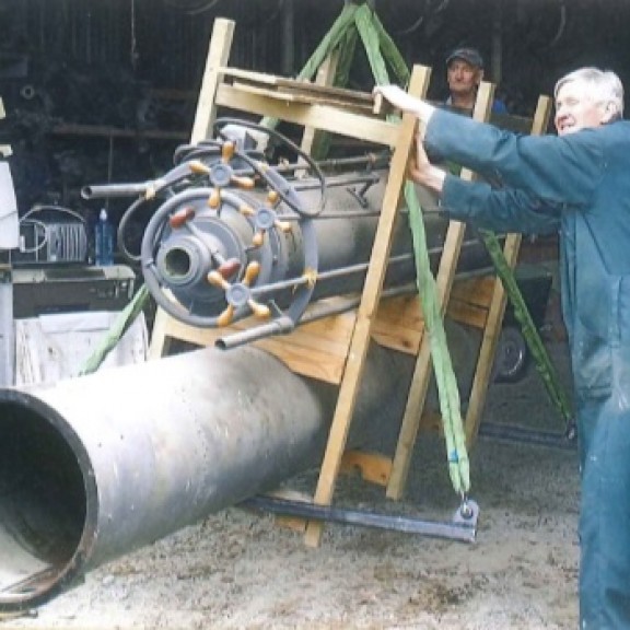 Two men transporting the brashear telescope