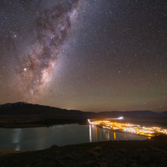 View from Mt John over Lake Tekapo and tekapo village with milky way