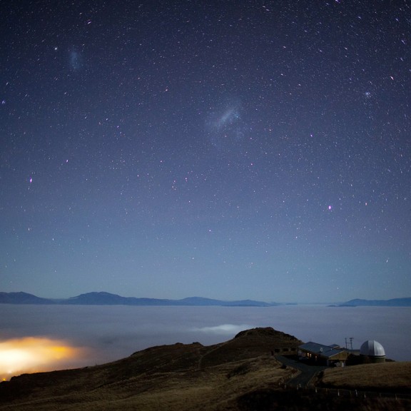 Looking down from Mount John with sea of clouds below and clear sky above